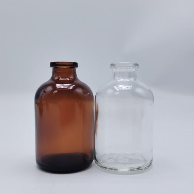 Moulded amber and clear medical glass bottle — 2